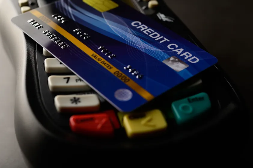 credit card sitting on top of a card reader